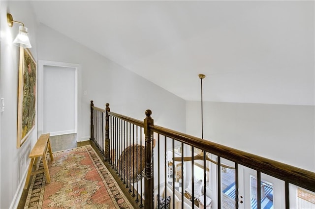 hall with hardwood / wood-style floors and vaulted ceiling