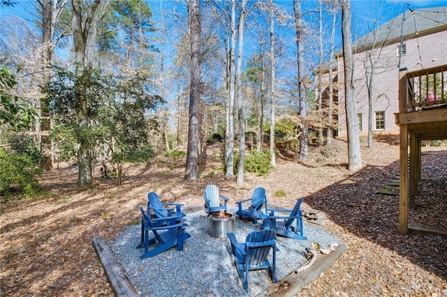 view of yard with a wooden deck and an outdoor fire pit