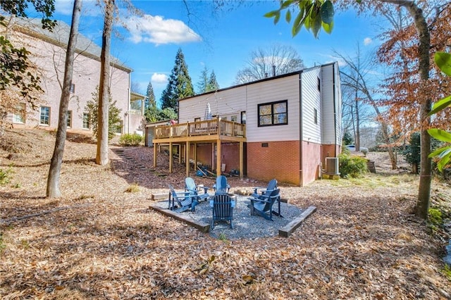 back of house featuring a wooden deck and an outdoor fire pit