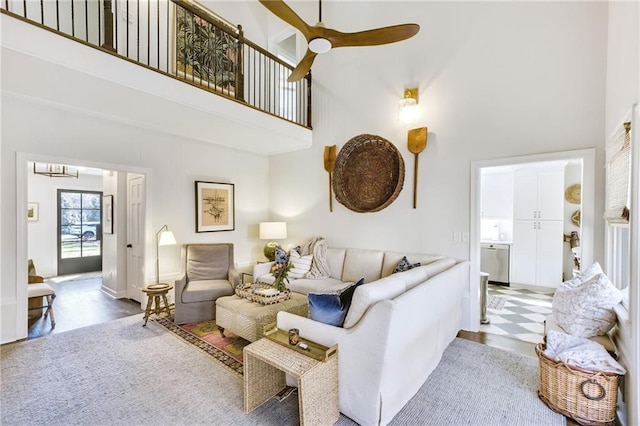 living room featuring a towering ceiling and ceiling fan