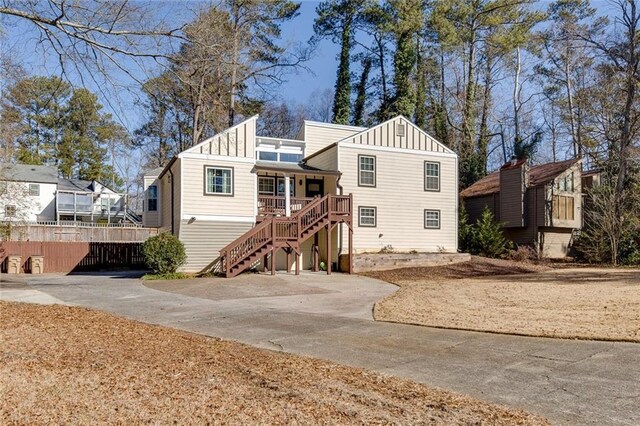 back of property with a porch and a patio area