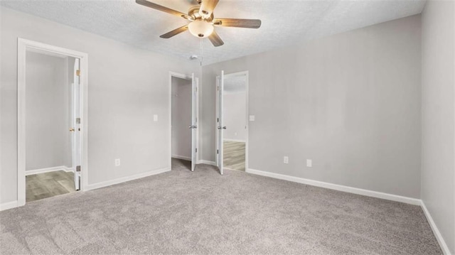 35 Ravenwood Dr, Rockmart, GA 30153 - unfurnished bedroom with carpet floors, a textured ceiling, a spacious closet, ensuite bathroom, and ceiling fan