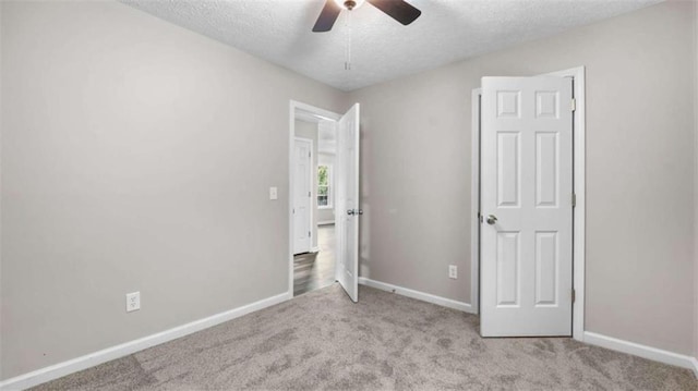 35 Ravenwood Dr, Rockmart, GA 30153 - unfurnished bedroom featuring a textured ceiling, carpet flooring, and a ceiling fan