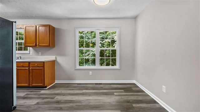 35 Ravenwood Dr, Rockmart, GA 30153 - kitchen with brown cabinetry, plenty of natural light, light countertops, and a textured ceiling