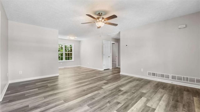 35 Ravenwood Dr, Rockmart, GA 30153 - unfurnished room featuring a ceiling fan, wood finished floors, a textured ceiling, and attic access