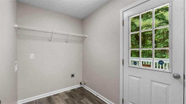 35 Ravenwood Dr, Rockmart, GA 30153 - laundry room featuring electric dryer hookup, plenty of natural light, dark wood-type flooring, and a textured ceiling