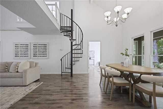 402 Roswell Green Ln, Roswell, GA 30075 - dining space with high vaulted ceiling, stairway, a chandelier, dark wood-type flooring, and baseboards