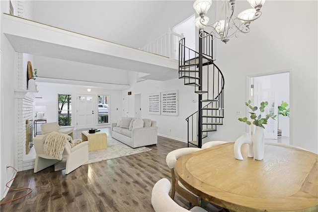 402 Roswell Green Ln, Roswell, GA 30075 - living room with a towering ceiling, a chandelier, stairs, wood finished floors, and baseboards