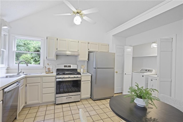402 Roswell Green Ln, Roswell, GA 30075 - kitchen with appliances with stainless steel finishes, washer and dryer, a sink, under cabinet range hood, and light tile patterned floors