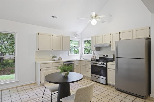 402 Roswell Green Ln, Roswell, GA 30075 - kitchen featuring appliances with stainless steel finishes, under cabinet range hood, ceiling fan, light tile patterned floors, and high vaulted ceiling