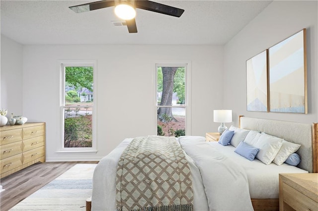 402 Roswell Green Ln, Roswell, GA 30075 - bedroom with multiple windows, wood finished floors, and a ceiling fan