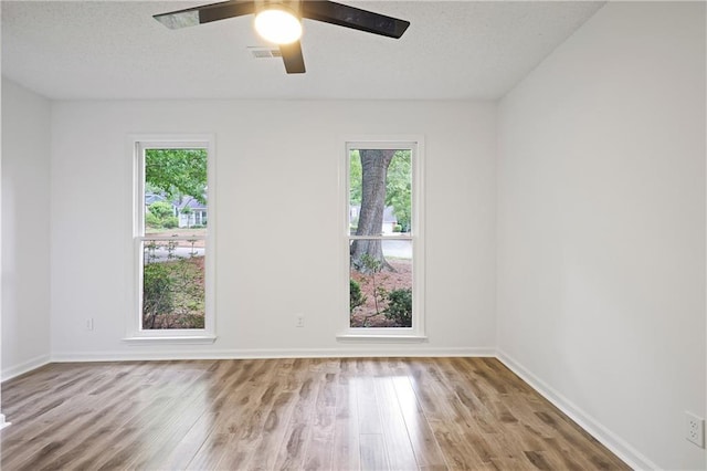 402 Roswell Green Ln, Roswell, GA 30075 - unfurnished room with plenty of natural light, wood finished floors, and baseboards
