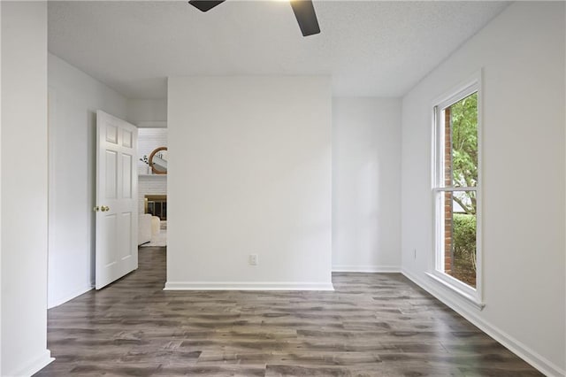 402 Roswell Green Ln, Roswell, GA 30075 - unfurnished room with a ceiling fan, dark wood-style floors, baseboards, and a textured ceiling