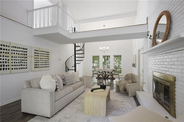 402 Roswell Green Ln, Roswell, GA 30075 - living room with stairs, wood finished floors, a towering ceiling, a fireplace, and a chandelier