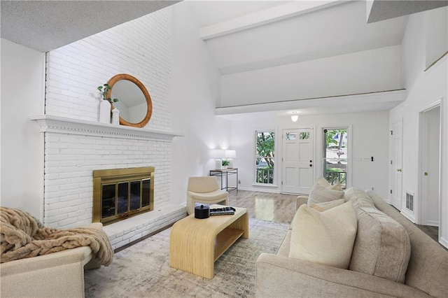402 Roswell Green Ln, Roswell, GA 30075 - living room with high vaulted ceiling, beamed ceiling, a fireplace, and wood finished floors