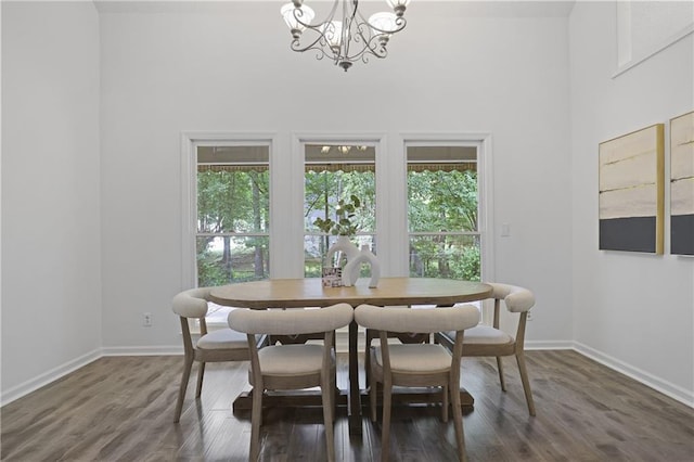 402 Roswell Green Ln, Roswell, GA 30075 - dining area featuring a chandelier, plenty of natural light, baseboards, a towering ceiling, and dark wood finished floors