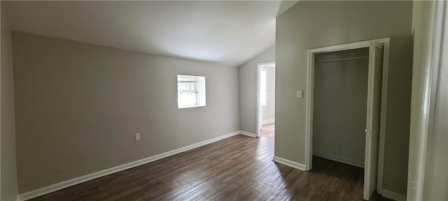 2917 Joe Jerkins Blvd, Austell, GA 30106 - unfurnished bedroom featuring lofted ceiling, dark wood-style floors, and baseboards