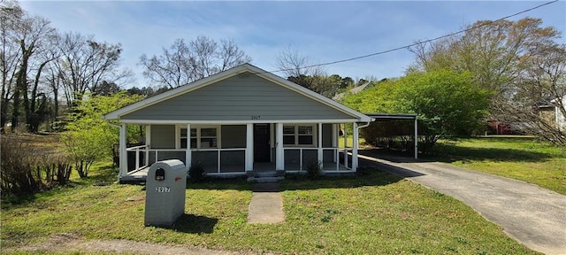2917 Joe Jerkins Blvd, Austell, GA 30106 - bungalow-style home with driveway, a carport, covered porch, and a front yard