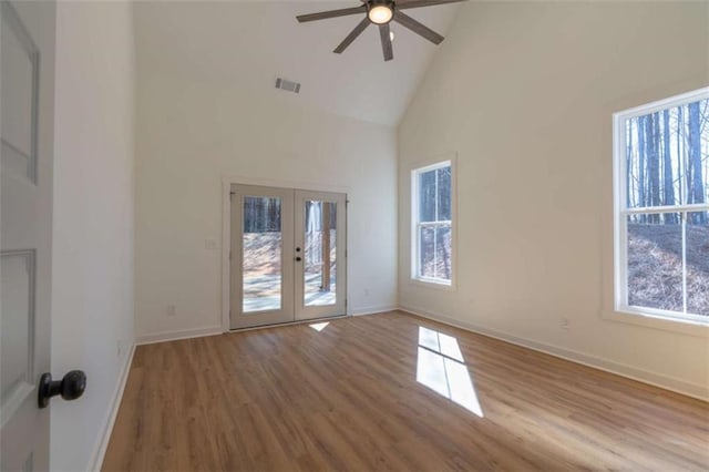 1250 Hays Mill Rd, Carrollton, GA 30117 - empty room featuring french doors, high vaulted ceiling, healthy amount of natural light, wood finished floors, and baseboards