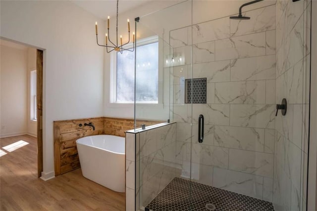 1250 Hays Mill Rd, Carrollton, GA 30117 - full bath featuring a chandelier, a freestanding tub, wood finished floors, and a shower stall
