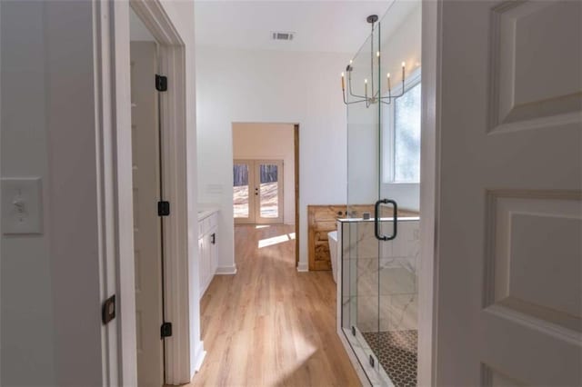 1250 Hays Mill Rd, Carrollton, GA 30117 - full bath with french doors, a shower stall, wood finished floors, and plenty of natural light