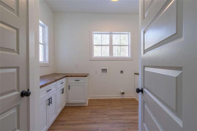 1250 Hays Mill Rd, Carrollton, GA 30117 - laundry room with hookup for an electric dryer, light wood-type flooring, washer hookup, cabinet space, and baseboards