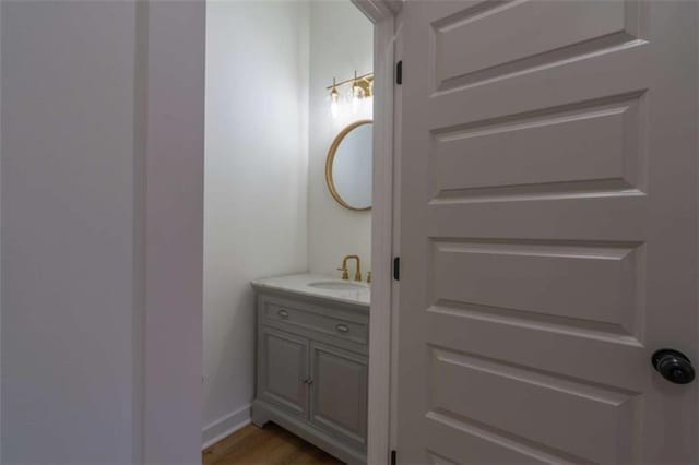 1250 Hays Mill Rd, Carrollton, GA 30117 - bathroom with vanity, wood finished floors, and baseboards