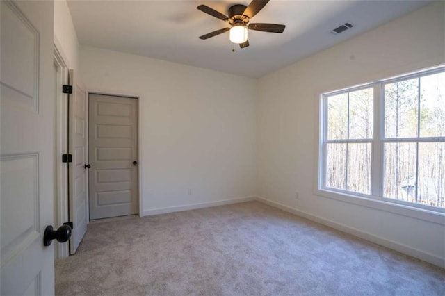 1250 Hays Mill Rd, Carrollton, GA 30117 - empty room with light carpet, plenty of natural light, a ceiling fan, and baseboards