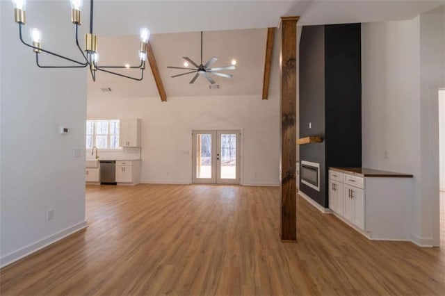 1250 Hays Mill Rd, Carrollton, GA 30117 - unfurnished living room with high vaulted ceiling, a chandelier, light wood finished floors, baseboards, and french doors