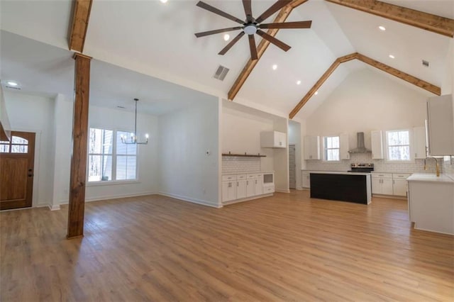 1250 Hays Mill Rd, Carrollton, GA 30117 - unfurnished living room with high vaulted ceiling, a chandelier, a ceiling fan, beam ceiling, and light wood-style flooring