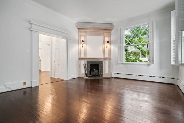 unfurnished living room with crown molding, a fireplace, dark hardwood / wood-style floors, and baseboard heating