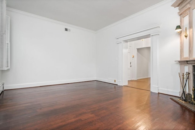 spare room with ornamental molding and dark hardwood / wood-style flooring