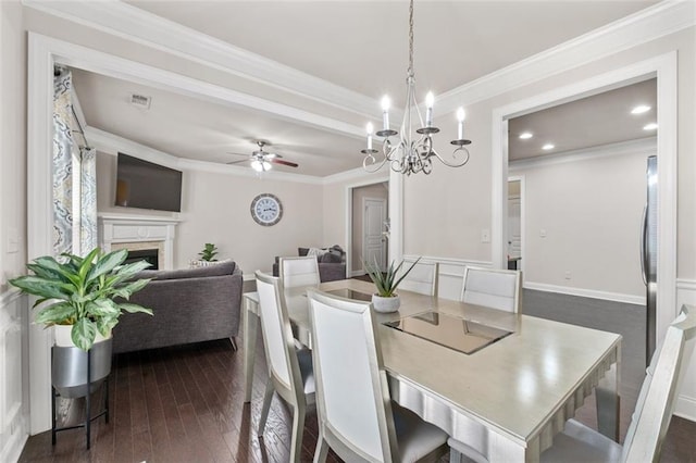 dining area featuring crown molding, ceiling fan, and dark hardwood / wood-style floors