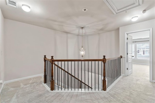 hallway featuring light colored carpet