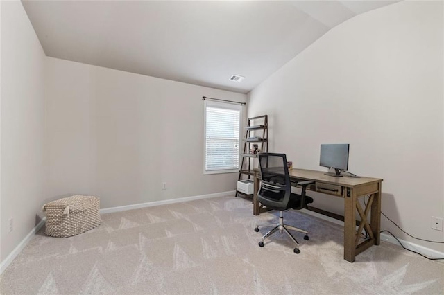 carpeted office with vaulted ceiling