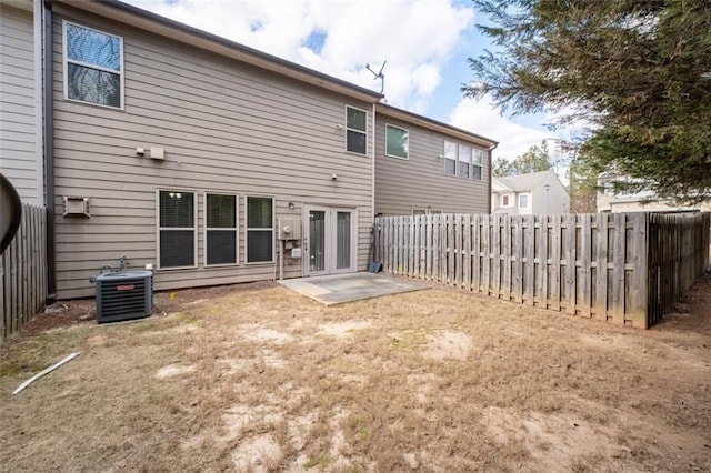 back of house featuring a patio, a wall mounted AC, and central air condition unit