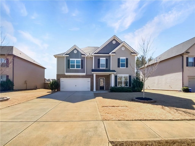 traditional-style home featuring an attached garage and concrete driveway