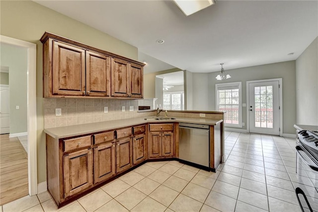 3426 Olivia Grace Way, Dacula, GA 30019 - kitchen with appliances with stainless steel finishes, a sink, brown cabinets, tasteful backsplash, and light tile patterned floors