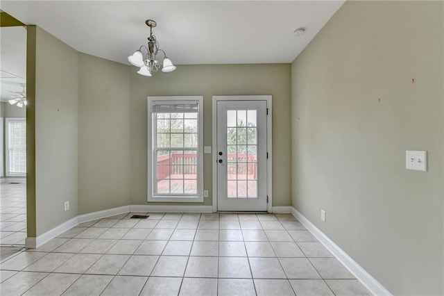 3426 Olivia Grace Way, Dacula, GA 30019 - unfurnished dining area with a chandelier, light tile patterned floors, and baseboards