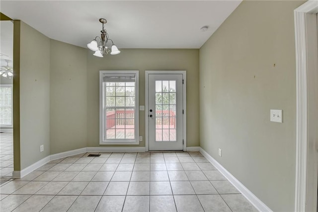 3426 Olivia Grace Way, Dacula, GA 30019 - unfurnished dining area featuring a chandelier, light tile patterned floors, and baseboards