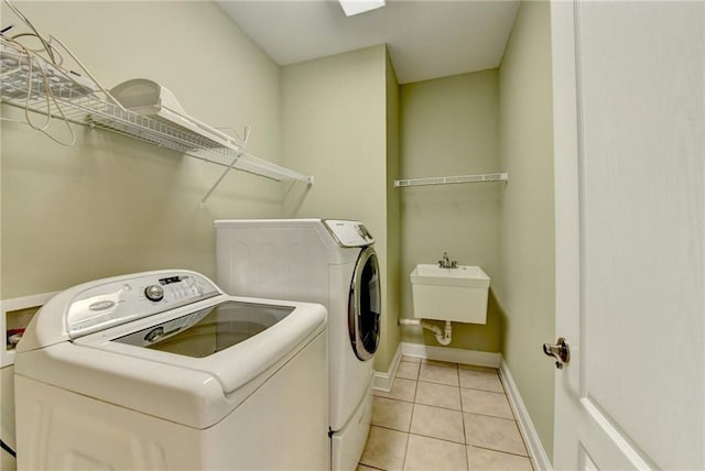 3426 Olivia Grace Way, Dacula, GA 30019 - clothes washing area with washer and dryer, light tile patterned floors, and baseboards