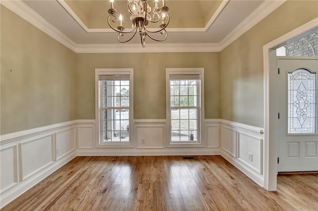 3426 Olivia Grace Way, Dacula, GA 30019 - foyer featuring a chandelier, a raised ceiling, wainscoting, light wood-type flooring, and ornamental molding