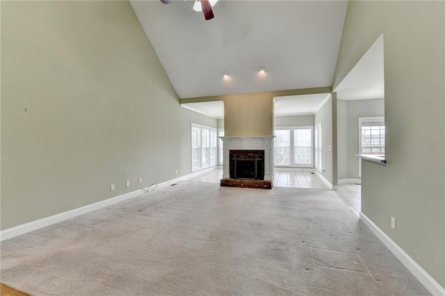 3426 Olivia Grace Way, Dacula, GA 30019 - unfurnished living room featuring vaulted ceiling, baseboards, light colored carpet, a ceiling fan, and plenty of natural light