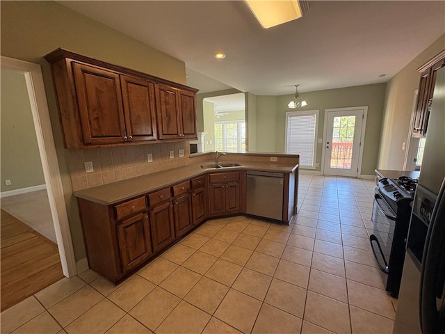 3426 Olivia Grace Way, Dacula, GA 30019 - kitchen with stainless steel dishwasher, black gas stove, a sink, light tile patterned floors, and recessed lighting