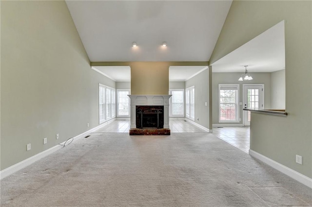 3426 Olivia Grace Way, Dacula, GA 30019 - unfurnished living room featuring baseboards, carpet, a chandelier, vaulted ceiling, and a brick fireplace