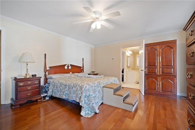 kitchen with a breakfast bar, white appliances, crown molding, light wood-type flooring, and a kitchen island