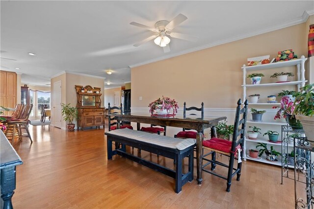 laundry room with cabinets, ornamental molding, ceiling fan, sink, and washing machine and dryer