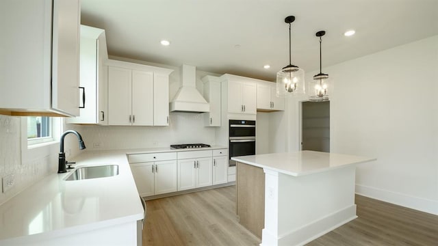 1514 Gatekeeper Ter, Marietta, GA 30066 - kitchen with a sink, custom exhaust hood, gas cooktop, light wood-style flooring, and recessed lighting