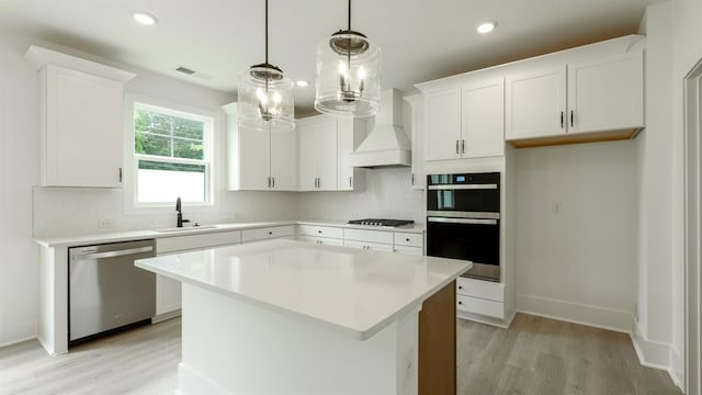 1514 Gatekeeper Ter, Marietta, GA 30066 - kitchen featuring stainless steel appliances, light wood finished floors, decorative backsplash, white cabinets, and recessed lighting