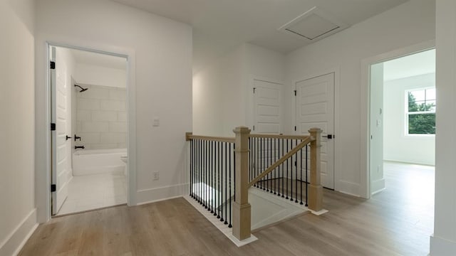 1514 Gatekeeper Ter, Marietta, GA 30066 - hallway featuring an upstairs landing, light wood finished floors, baseboards, and attic access
